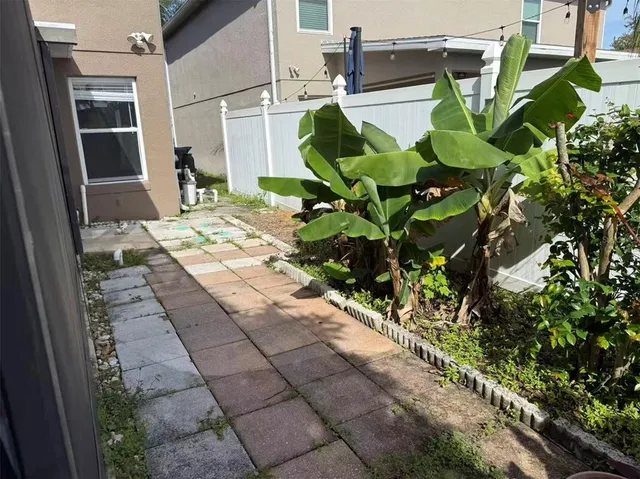 a backyard of a house with table and chairs