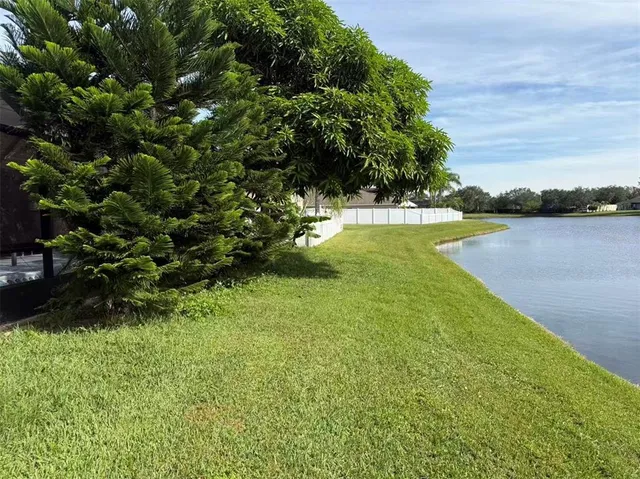 a view of a lake with houses in the back