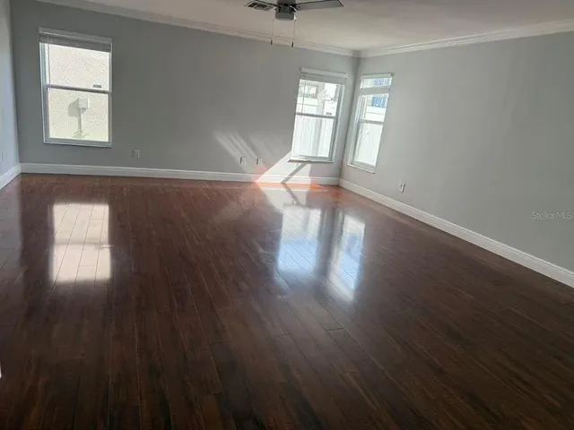 wooden floor in an empty room with a window