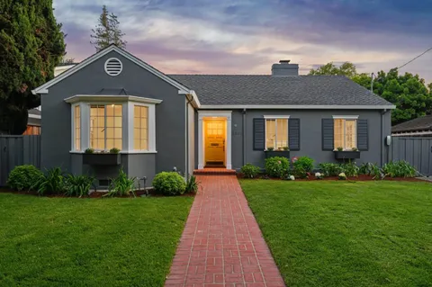 a front view of a house with garden