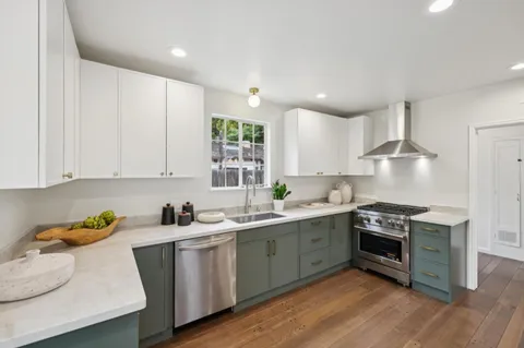 a kitchen with a sink stove and cabinets