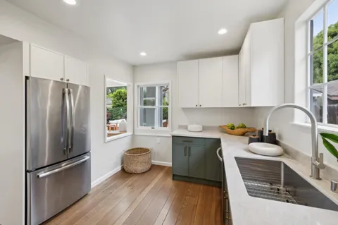 a kitchen with stainless steel appliances a refrigerator sink and cabinets