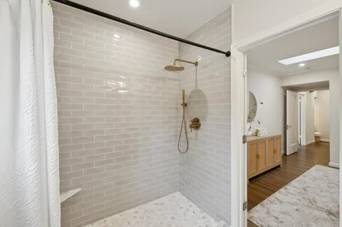 a bathroom with a shower and a sink