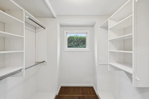 a view of walk in closet with empty racks