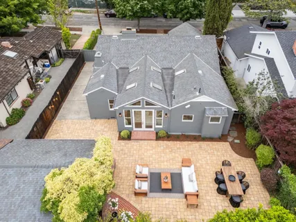an aerial view of a residential houses with city view