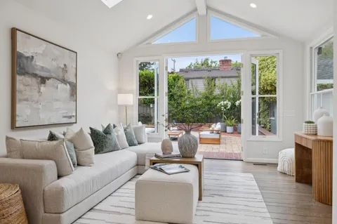 a living room with furniture and large windows