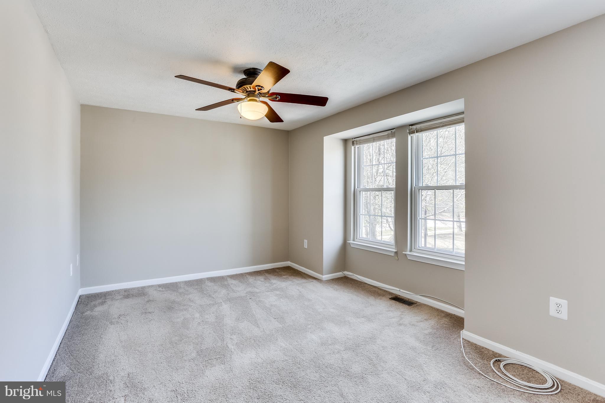 7204 Procopio Circle Columbia, MD 21046 - Photo 13 of 30 an empty room with windows and fan