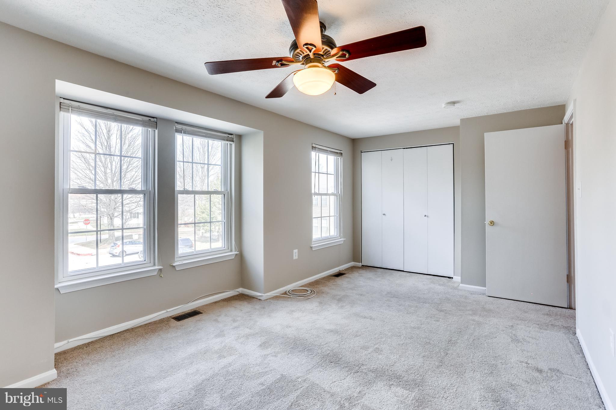 7204 Procopio Circle Columbia, MD 21046 - Photo 14 of 30 a view of an empty room with window and a ceiling fan