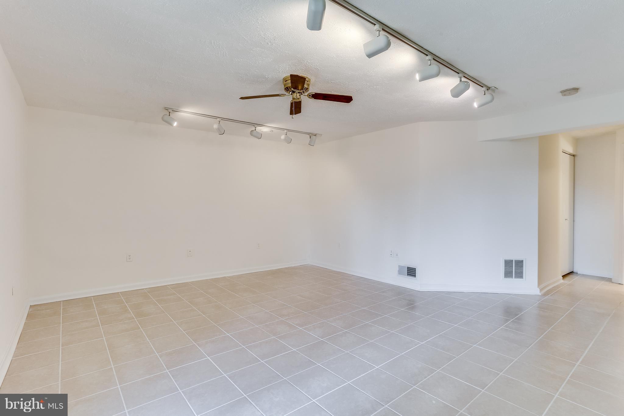 7204 Procopio Circle Columbia, MD 21046 - Photo 25 of 30 an empty room with a ceiling fan and carpet