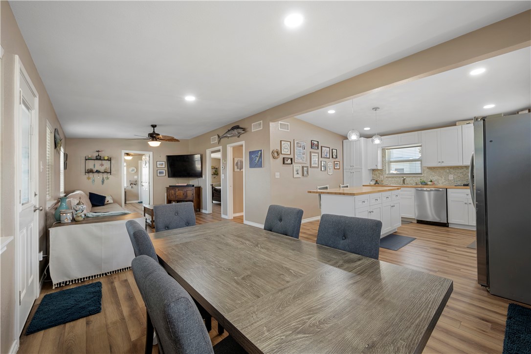 622 South Sandpiper Ingleside, TX 78362 - Photo 11 of 38 a large white kitchen with lots of counter space dining table and stainless steel appliances