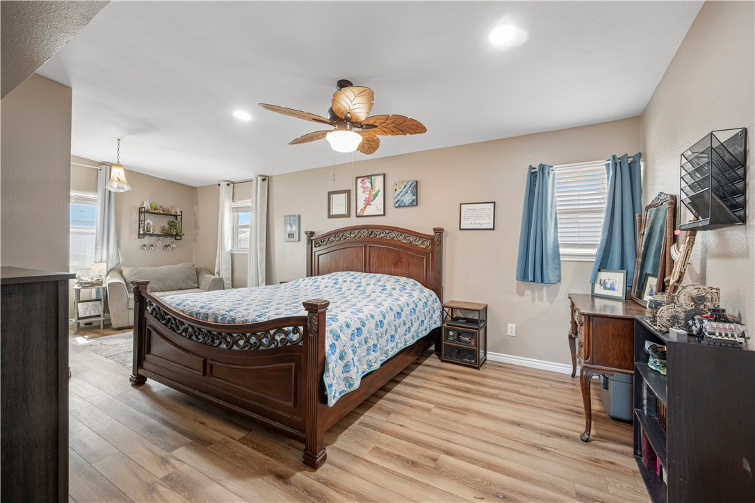 622 South Sandpiper Ingleside, TX 78362 - Photo 13 of 38 a spacious bedroom with a bed and wooden floor