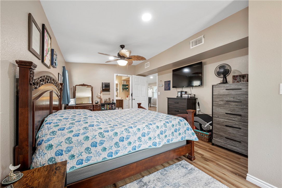 622 South Sandpiper Ingleside, TX 78362 - Photo 15 of 38 a bedroom with a large bed a flat tv screen and dresser