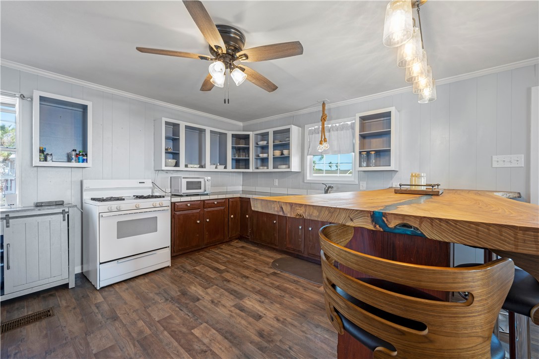 622 South Sandpiper Ingleside, TX 78362 - Photo 28 of 38 a kitchen with stainless steel appliances granite countertop a sink and cabinets