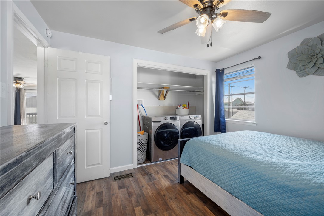 622 South Sandpiper Ingleside, TX 78362 - Photo 32 of 38 a bedroom with a bed and a chandelier