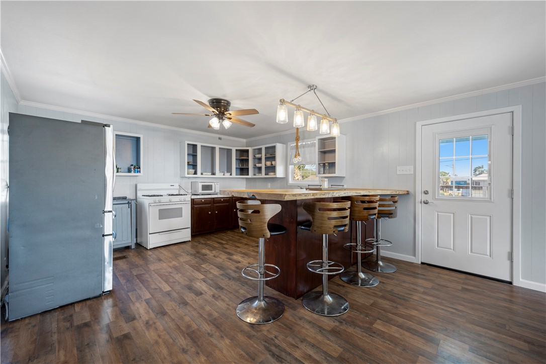 622 South Sandpiper Ingleside, TX 78362 - Photo 34 of 38 a view of kitchen with dining table chairs and wooden floor