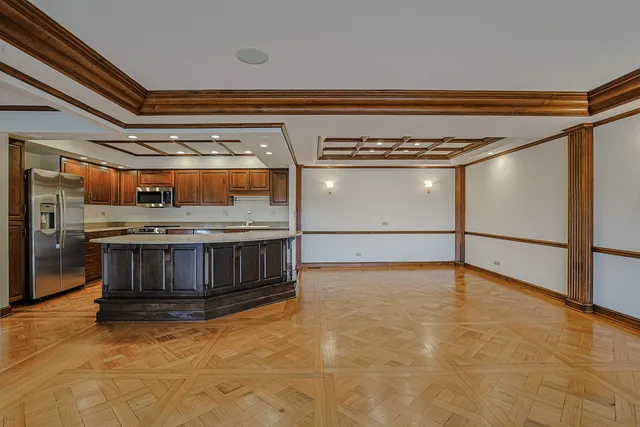 a view of kitchen with stainless steel appliances granite countertop a stove and a view of the kitchen