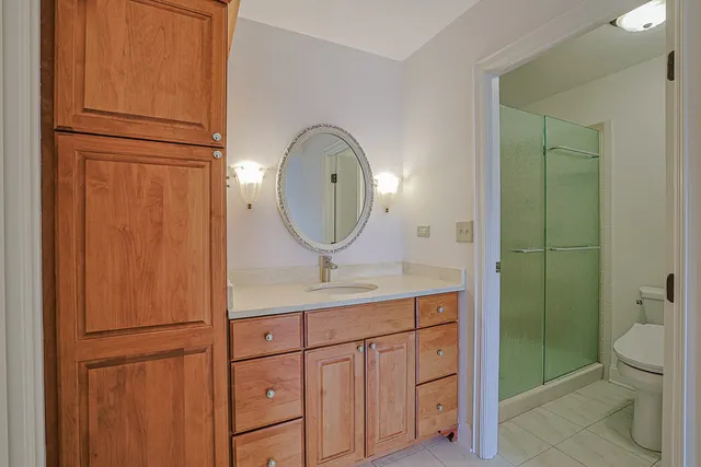 a bathroom with a mirror sink and vanity