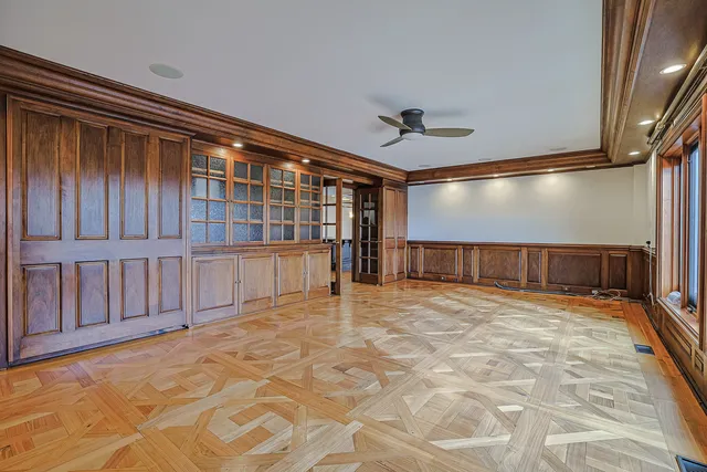 a bedroom with a large bed a flat tv screen and balcony