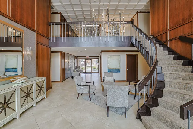 a lobby with furniture and floor to ceiling window