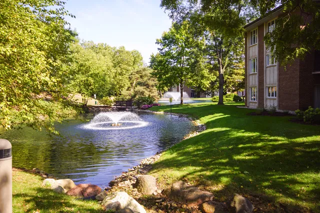 a view of a brick building next to a yard