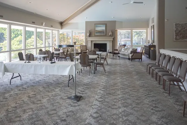 a living room with lots of furniture and a large window