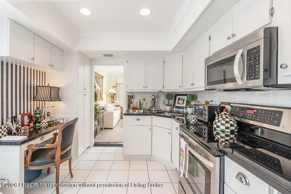 a kitchen with stainless steel appliances kitchen island granite countertop a stove and cabinets