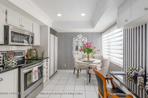 a kitchen with stainless steel appliances granite countertop a stove a sink dishwasher and cabinets with wooden floor