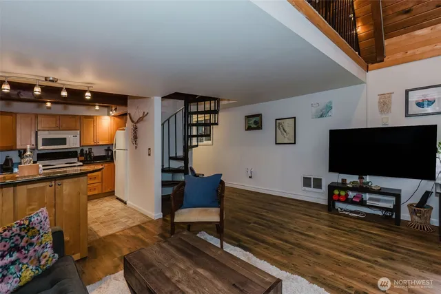 a kitchen with stainless steel appliances granite countertop a sink and a refrigerator
