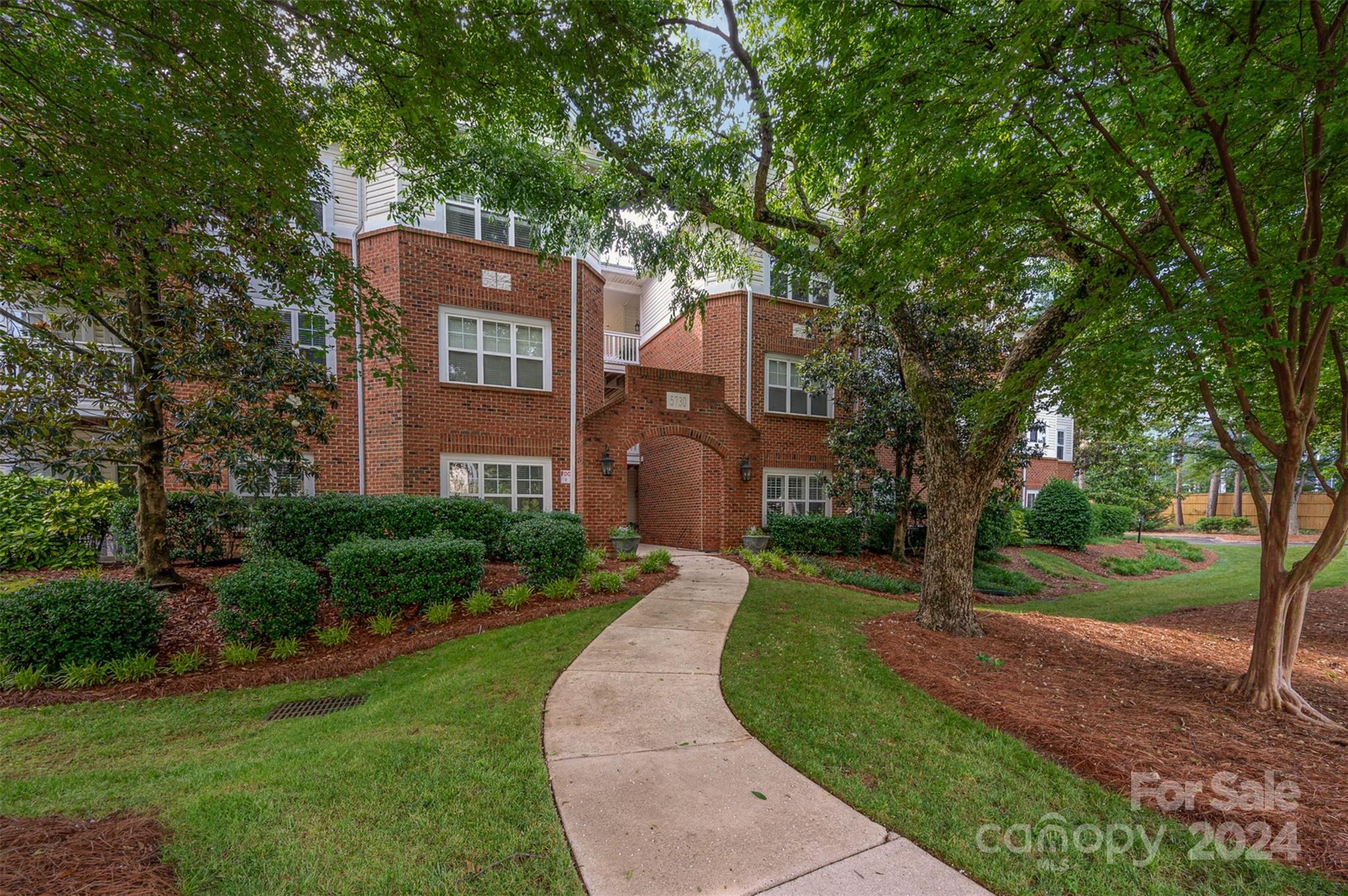 5730 Closeburn Road, Unit G Charlotte, NC 28210 - Photo 1 of 30 a front view of a house with a yard and trees