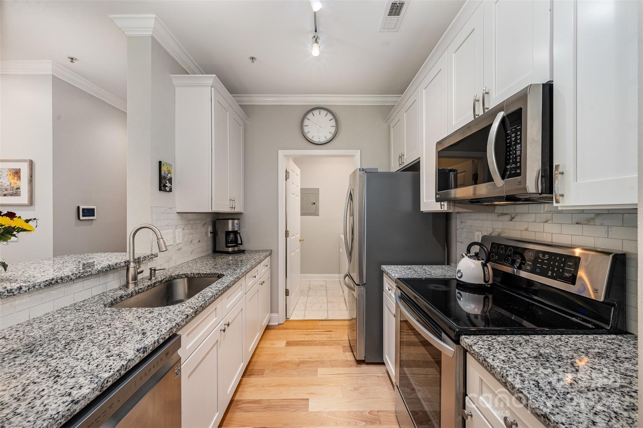 5730 Closeburn Road, Unit G Charlotte, NC 28210 - Photo 13 of 30 a kitchen with granite countertop stainless steel appliances a stove microwave and sink