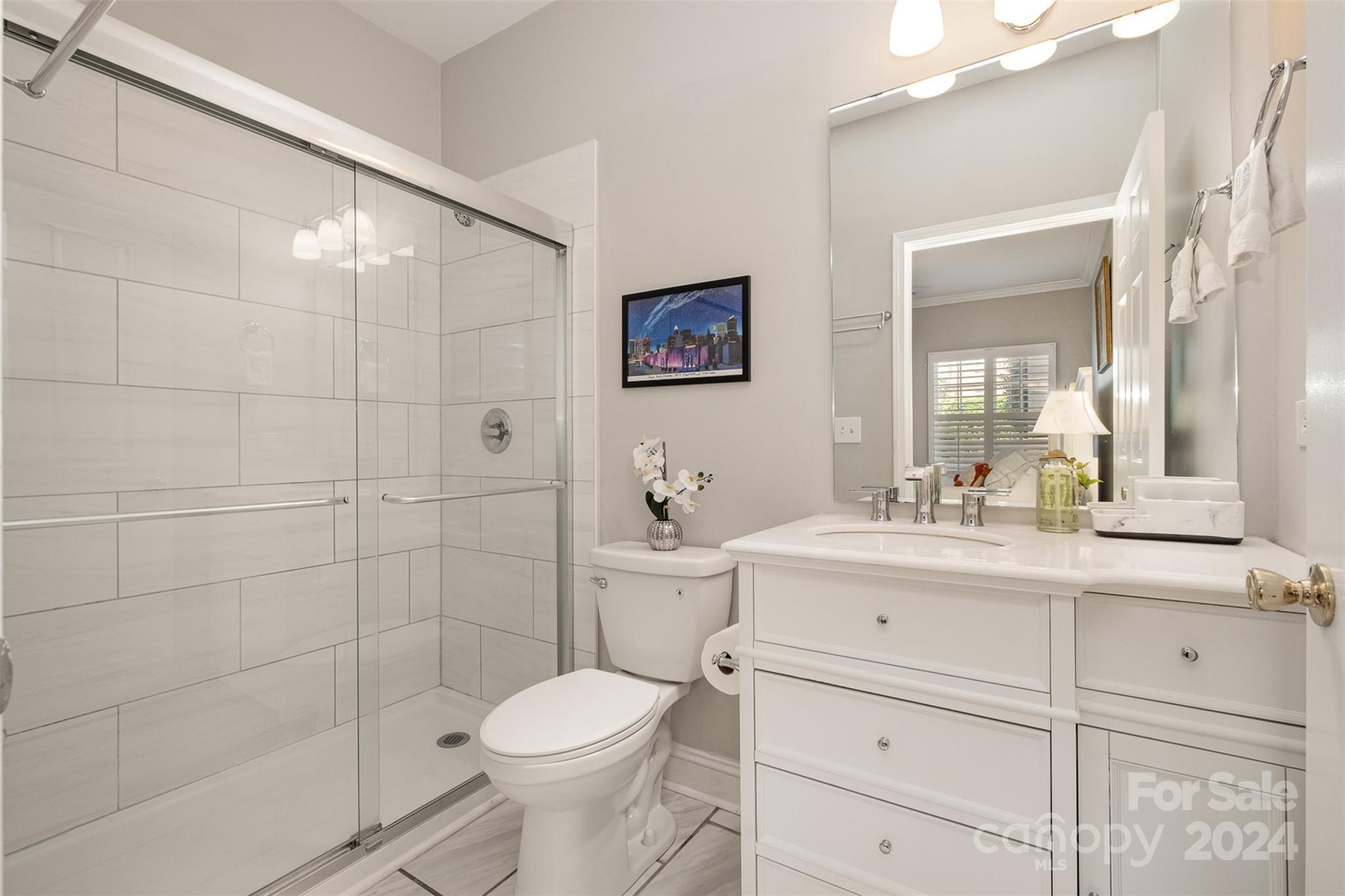 5730 Closeburn Road, Unit G Charlotte, NC 28210 - Photo 18 of 30 a bathroom with a sink a toilet and a mirror