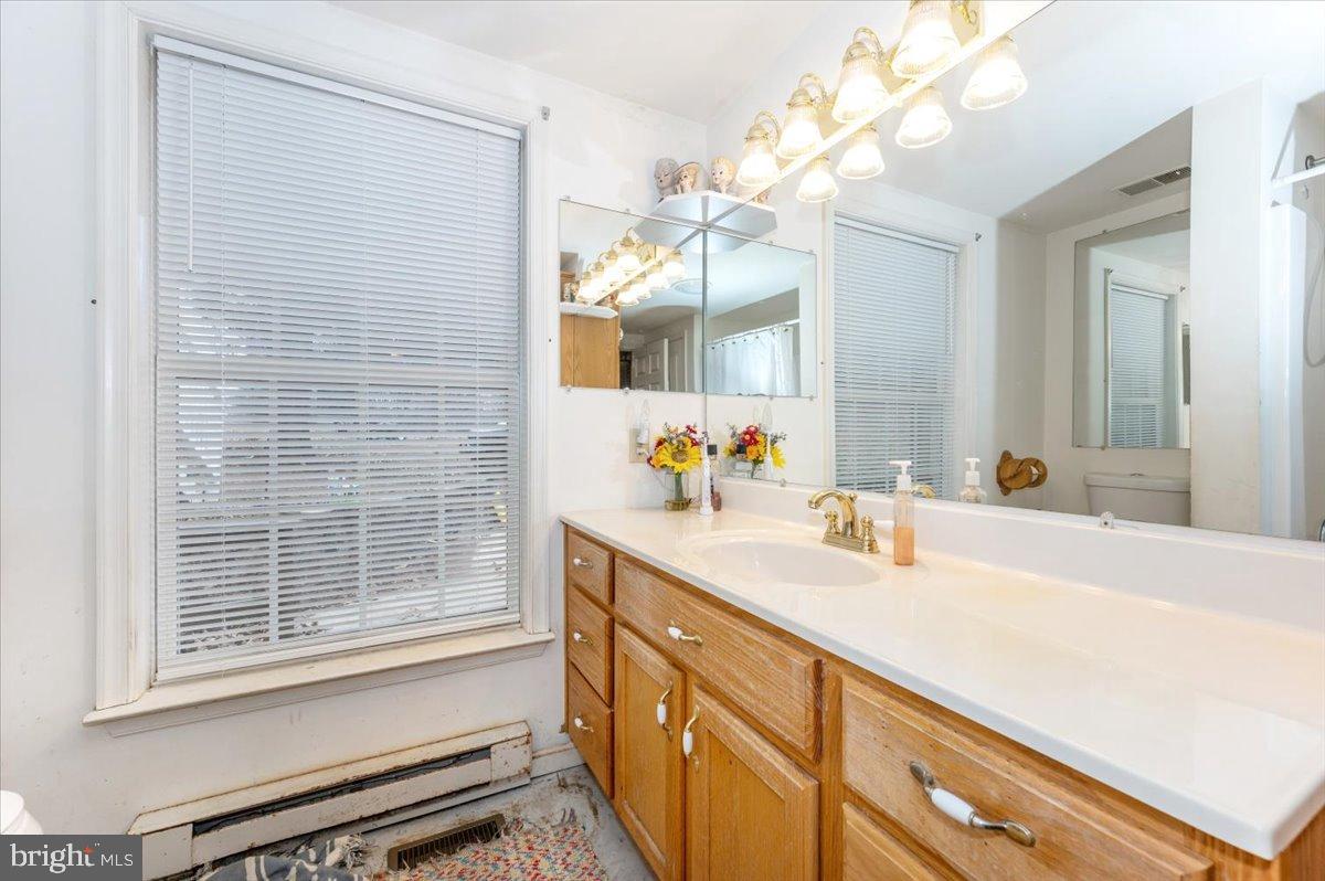 10891 Bethesda Church Road Damascus, MD 20872 - Photo 15 of 51 a bathroom with a sink a vanity and a mirror