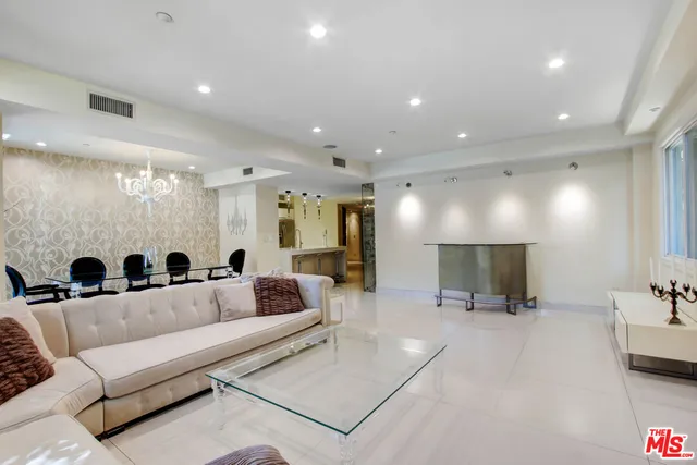 a living room with furniture and a mirror