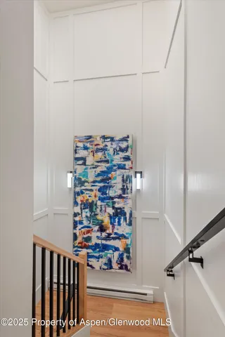 a view of kids room with racks on the wall