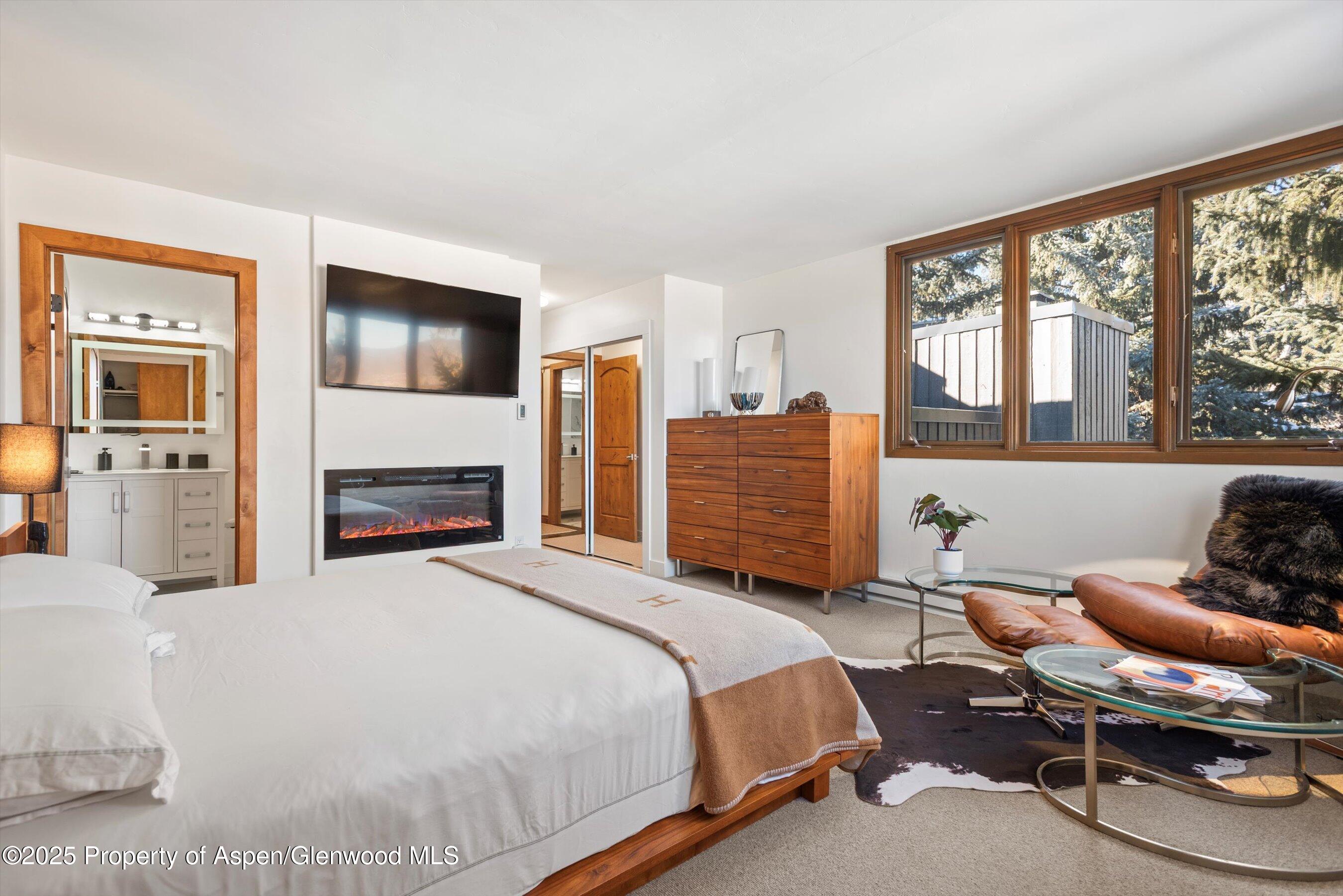 382 Meadow Ranch Road, Unit F4B Snowmass Village, CO 81615 - Photo 19 of 30 a bedroom with a bed and wooden floor