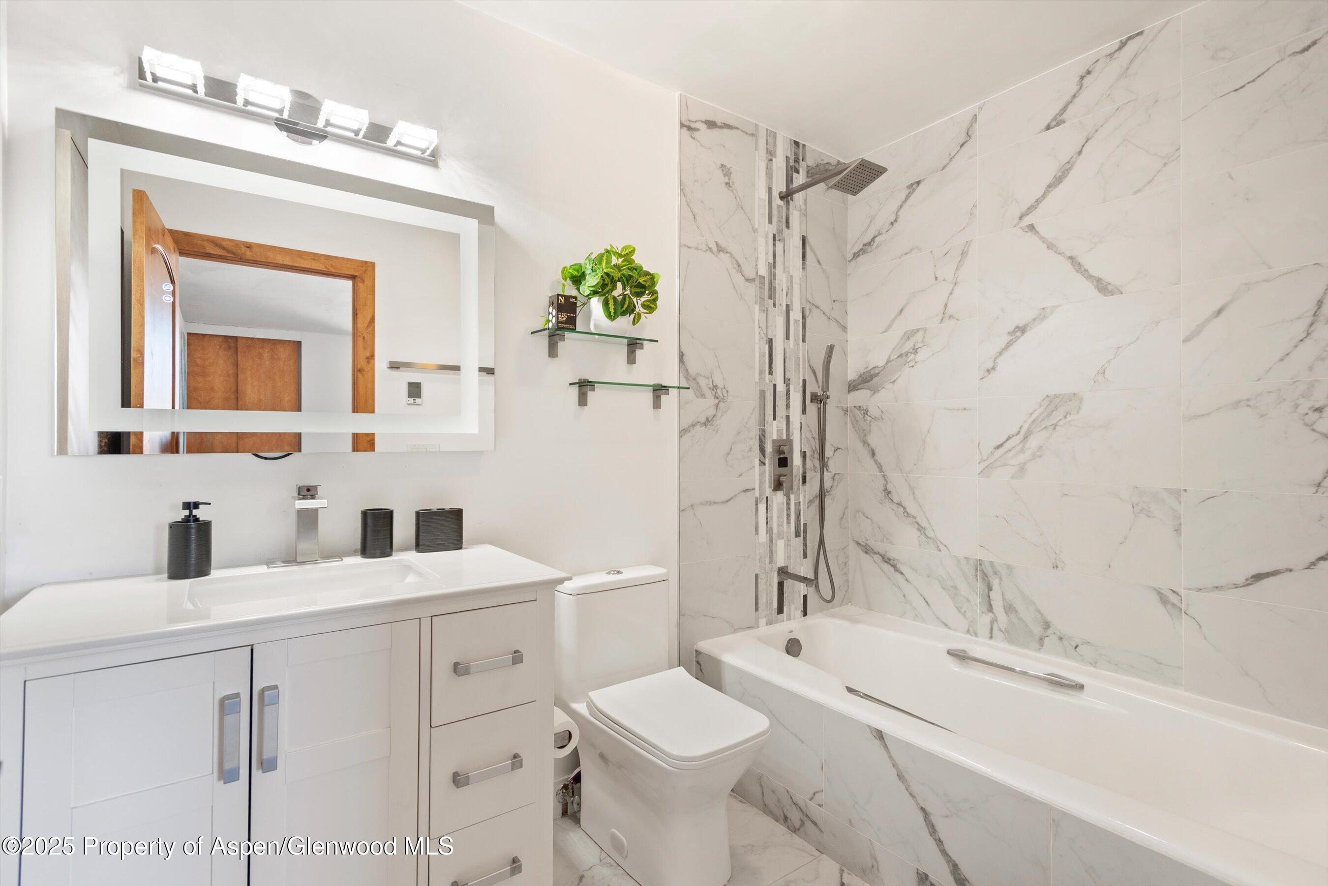 382 Meadow Ranch Road, Unit F4B Snowmass Village, CO 81615 - Photo 20 of 30 a bathroom with a sink and a mirror