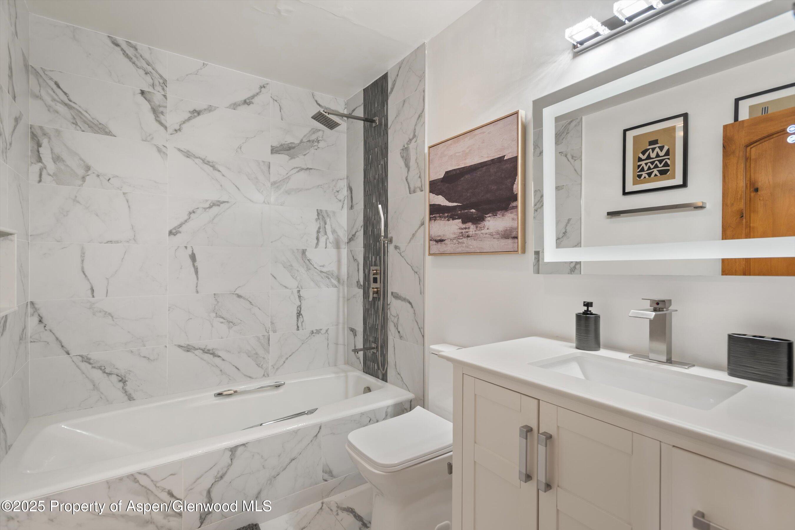 382 Meadow Ranch Road, Unit F4B Snowmass Village, CO 81615 - Photo 23 of 30 a bathroom with a sink a toilet and shower