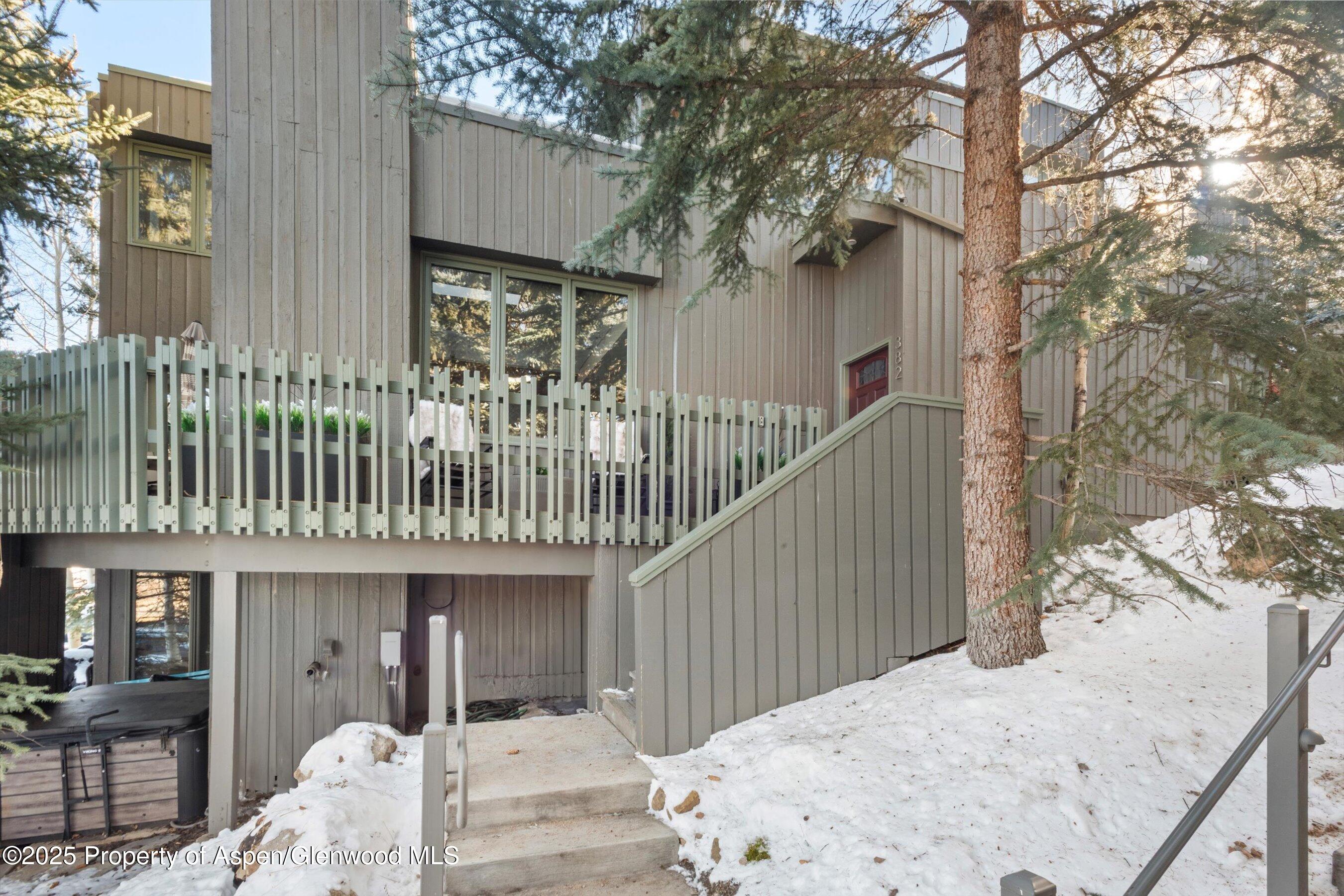 382 Meadow Ranch Road, Unit F4B Snowmass Village, CO 81615 - Photo 30 of 30 a view of a house with a wooden bench next to a road