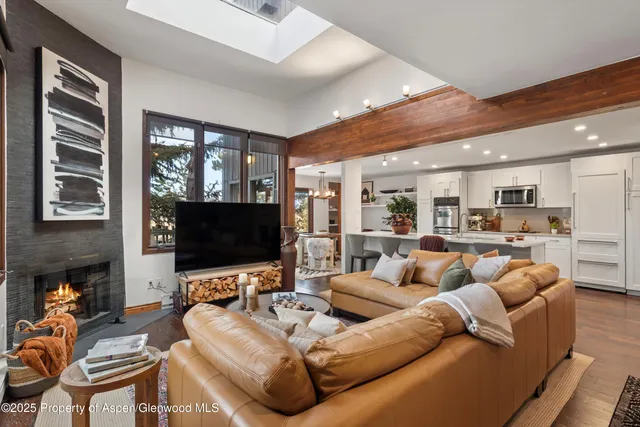 a living room with furniture flat screen tv and a fireplace