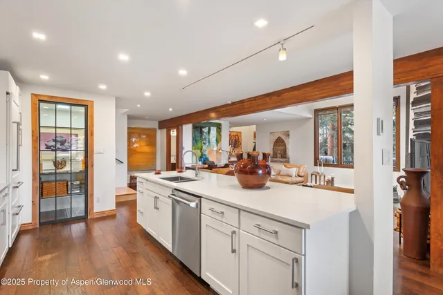 a view of a kitchen counter top space with stainless steel appliances granite countertop a sink and cabinets