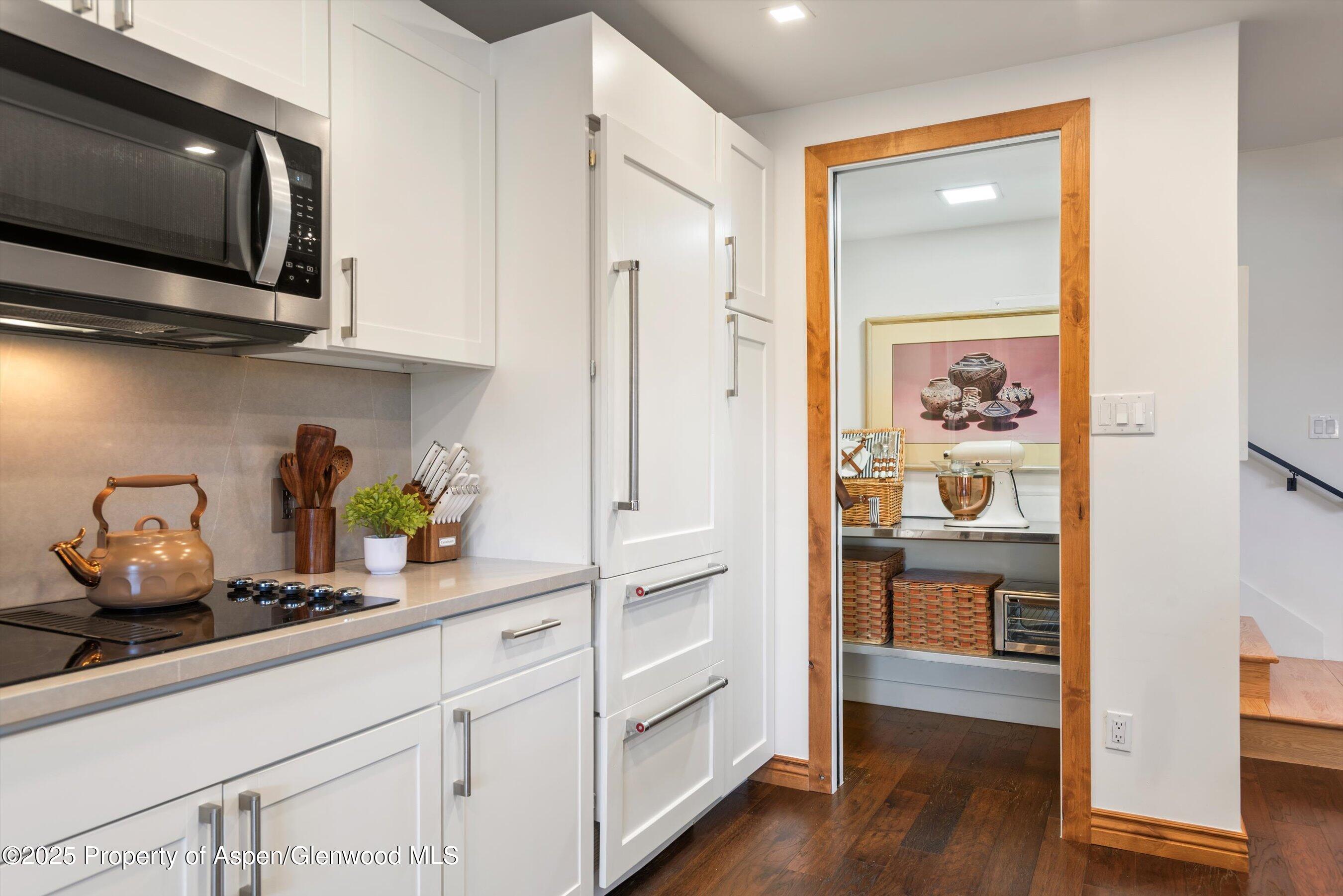 382 Meadow Ranch Road, Unit F4B Snowmass Village, CO 81615 - Photo 9 of 30 a kitchen with stainless steel appliances a microwave and cabinets