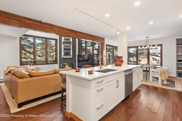 a kitchen with a stove and a white wooden cabinets