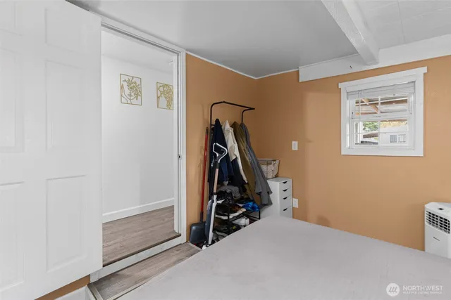 a bedroom with a bed and a window