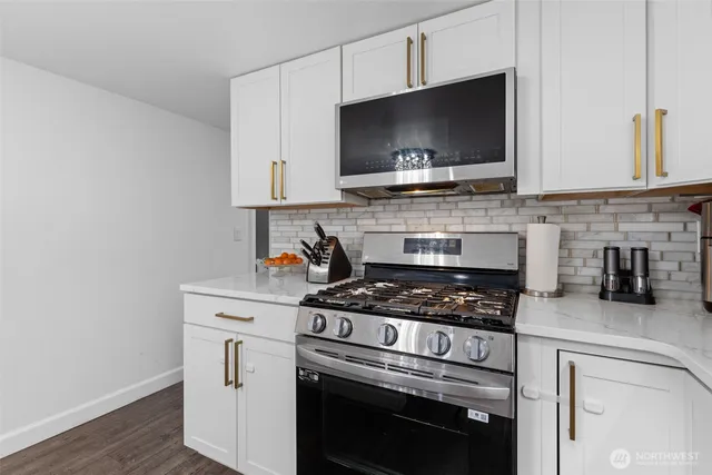 a kitchen with a stove and a microwave