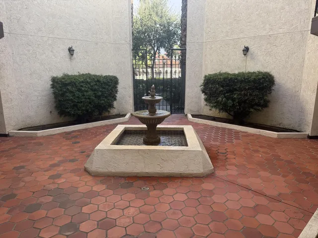 a walk in closet with wooden floor washer and dryer