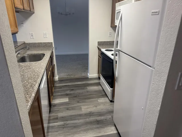 a kitchen with granite countertop a sink and a stove