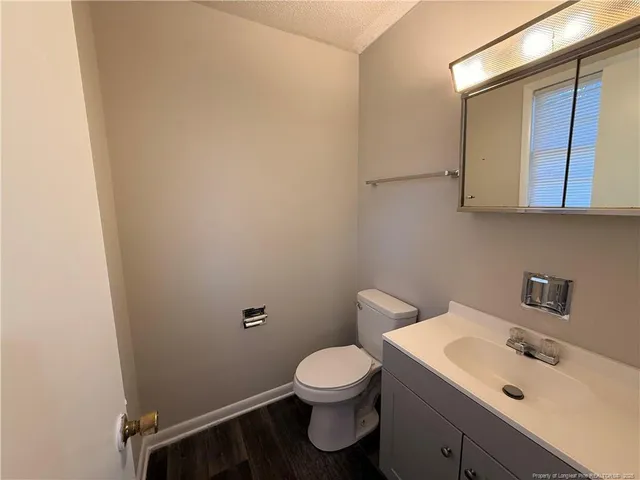 a bathroom with a sink a toilet and mirror