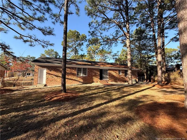 a view of a house with a large tree