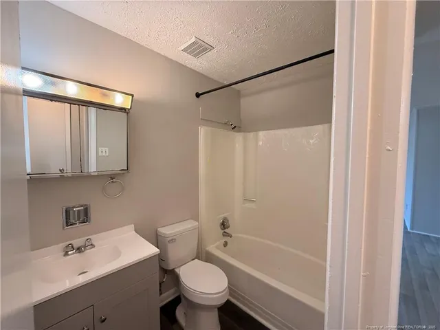 a bathroom with a sink mirror toilet and bathtub