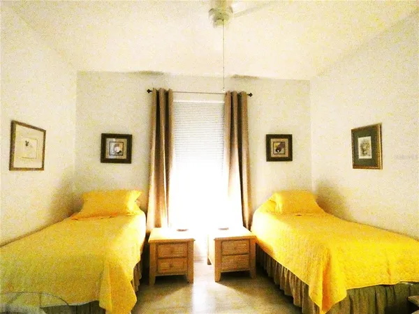 a bedroom with a bed and a night stand